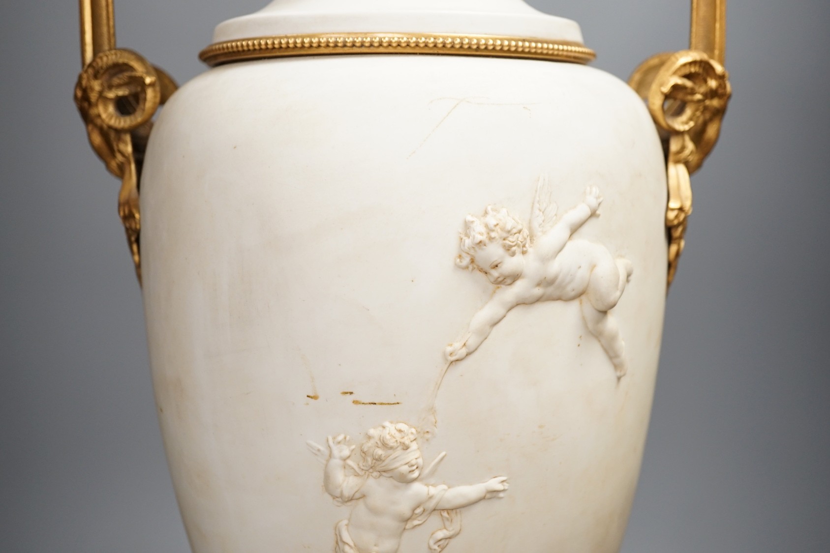 A large Louis XVI style ormolu mounted biscuit porcelain urn - 63cm tall